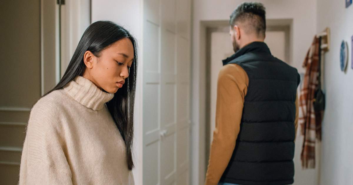 Man and woman walking past each other in a hallway