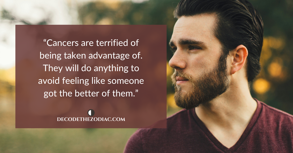 Man looking to his side with a quote about Cancer men being afraid of someone taking advantage of them in relationships